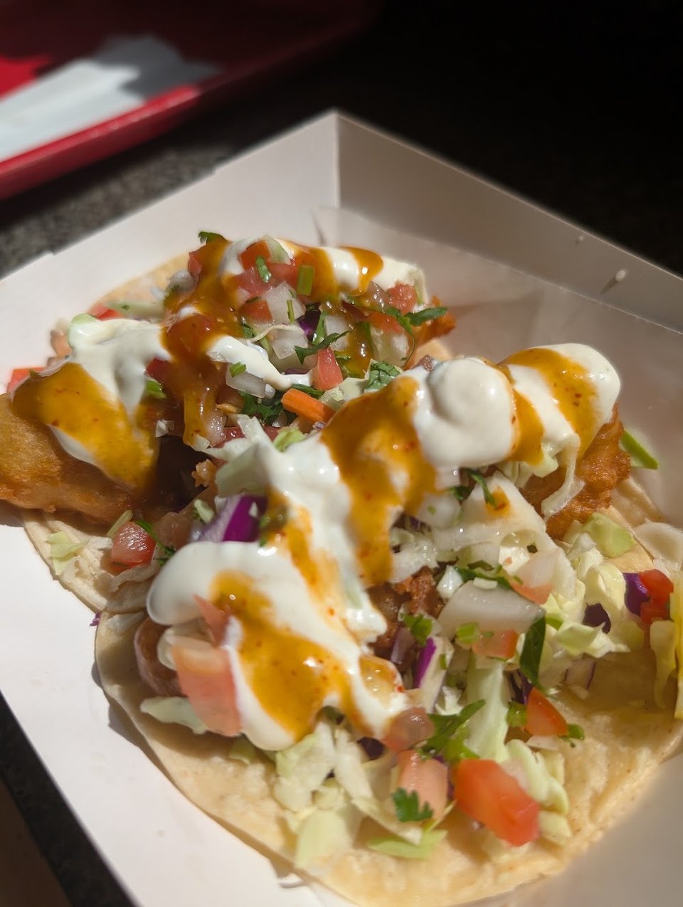 Menu board with tacos, burritos, and breakfast plates.